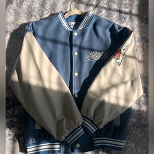 Blue and cream color varsity jacket.